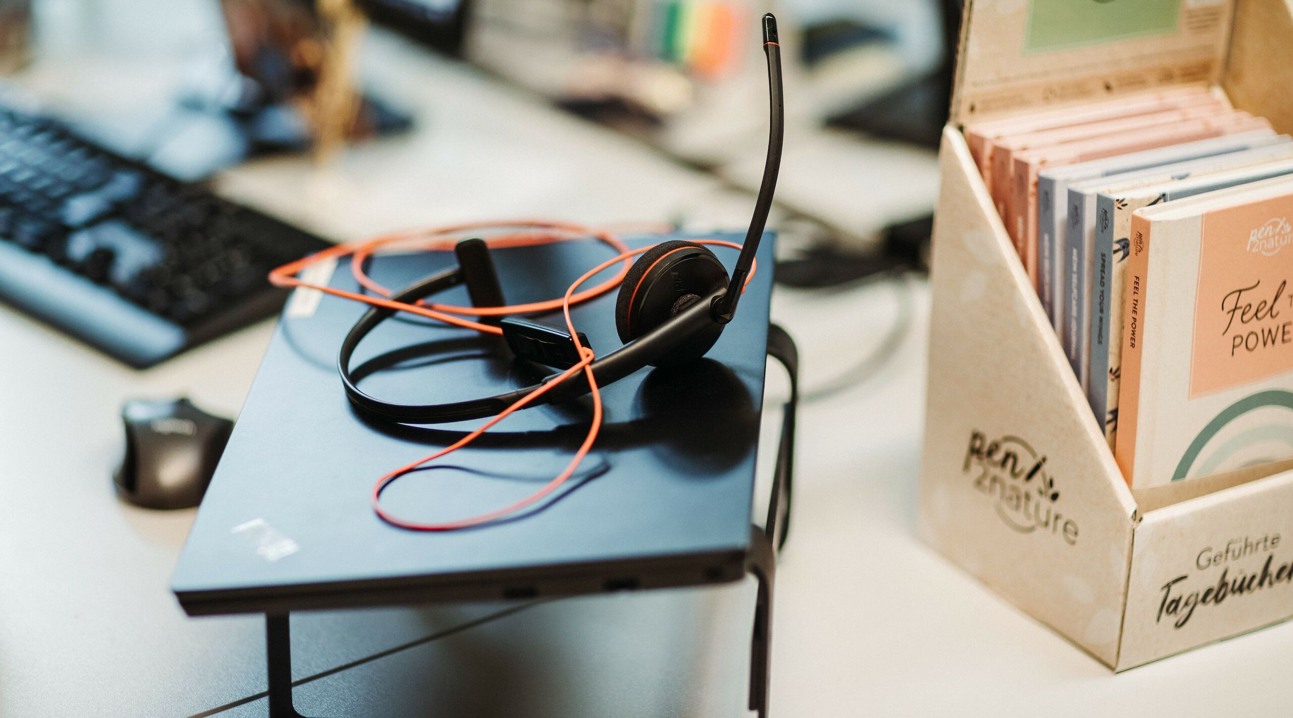 Ein Laptop mit einem Headset auf einem Schreibtisch
